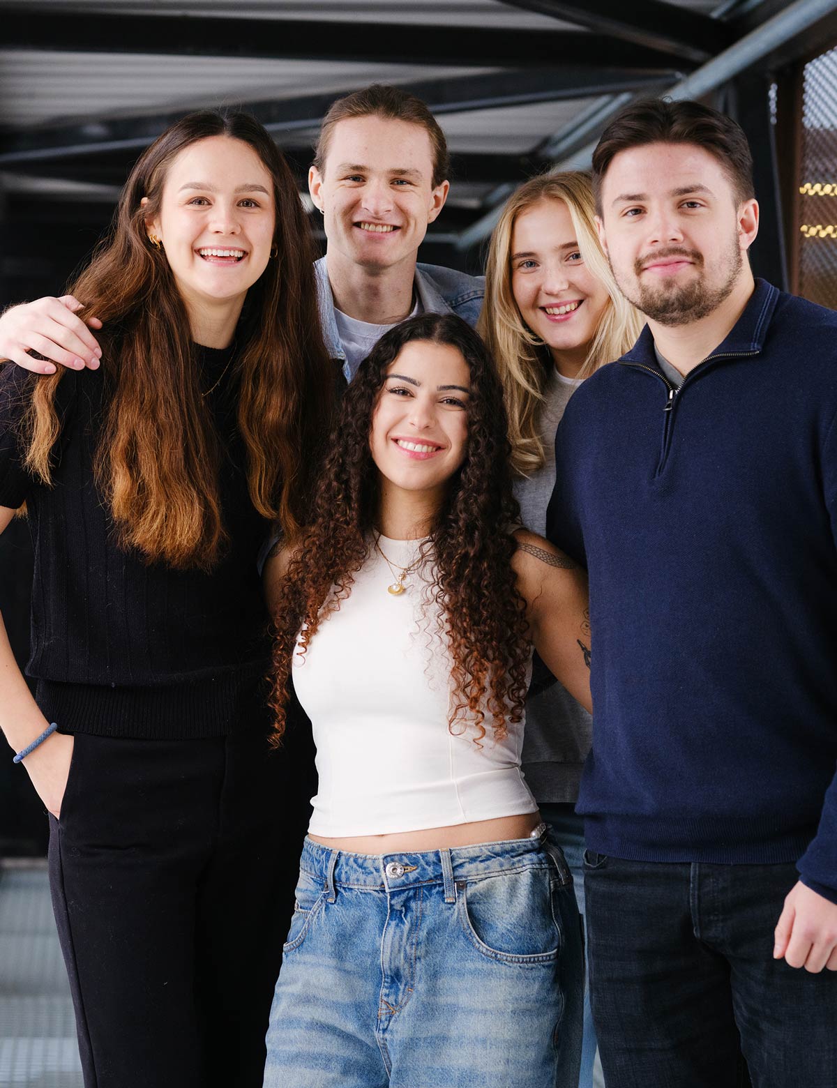 Five students smiling at the camera